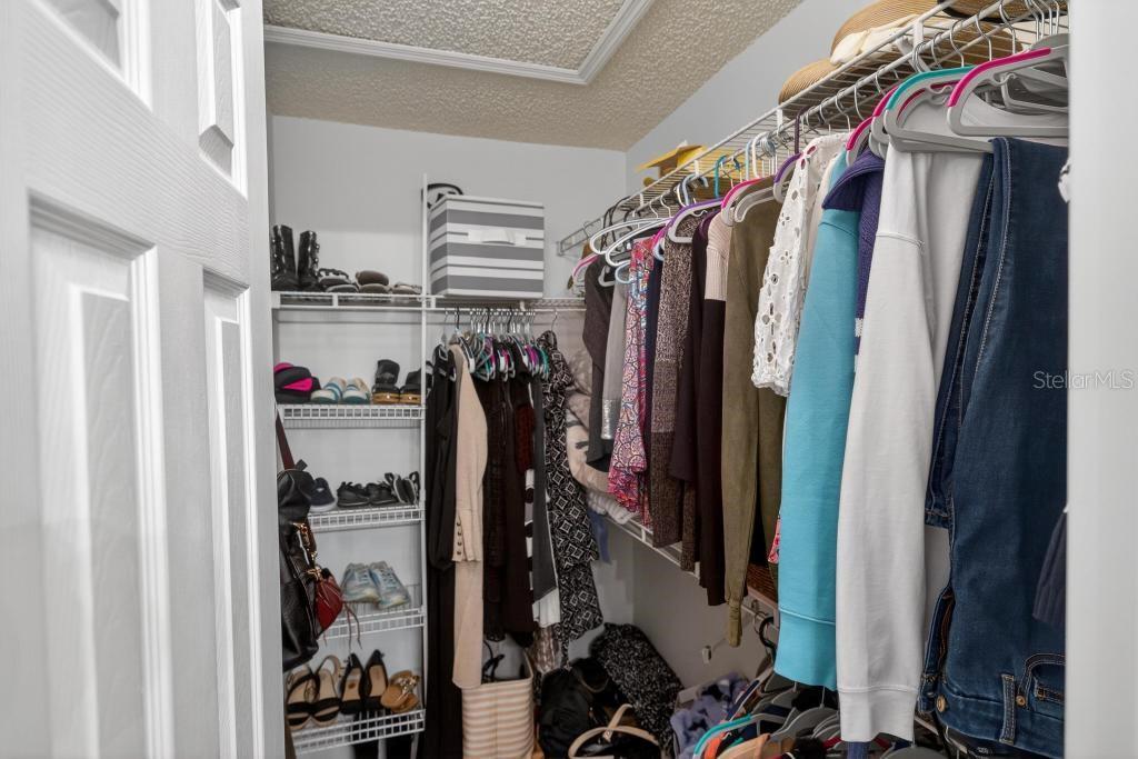 1332 Honey Road Apopka, FL 32712 - Photo 34 of 59 a view of walk in closet with clothes and shoes