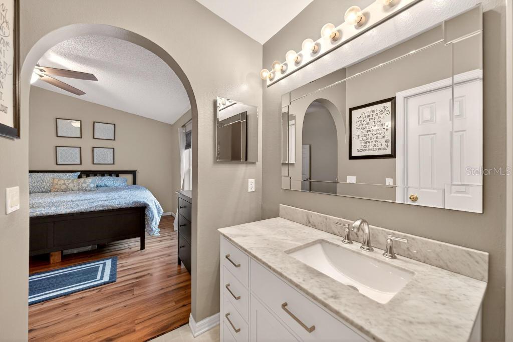 1332 Honey Road Apopka, FL 32712 - Photo 35 of 59 a en suite bathroom with a granite countertop sink and a mirror