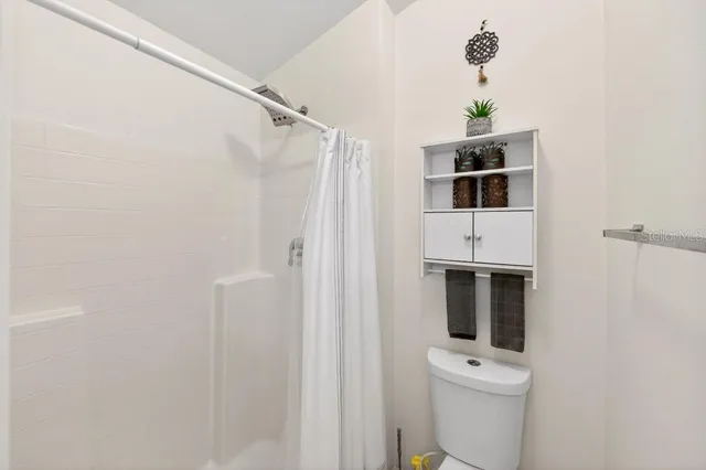 a living room with furniture a chandelier and a window