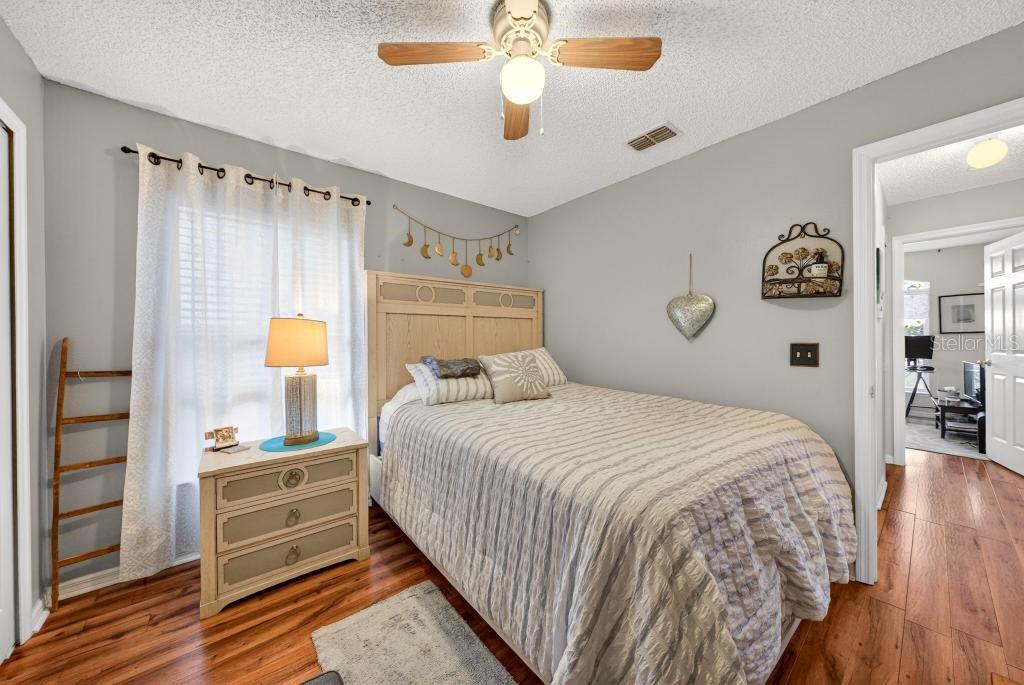 1332 Honey Road Apopka, FL 32712 - Photo 40 of 59 a bedroom with a bed and a chandelier