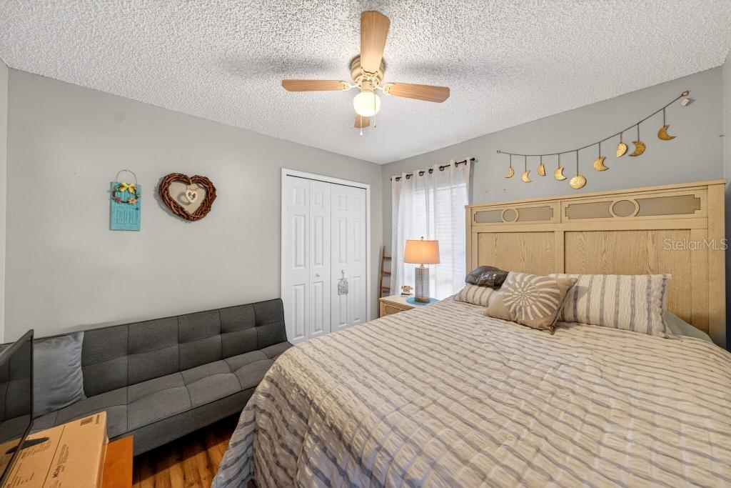 1332 Honey Road Apopka, FL 32712 - Photo 41 of 59 a bedroom with a bed and a chandelier