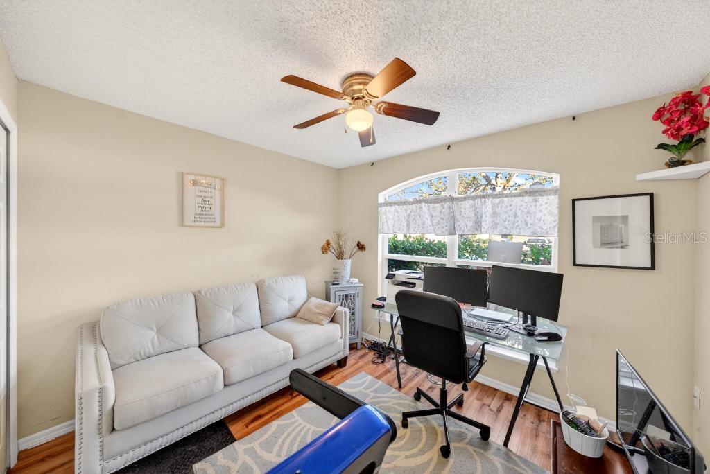 1332 Honey Road Apopka, FL 32712 - Photo 43 of 59 a living room with furniture a chandelier and a window