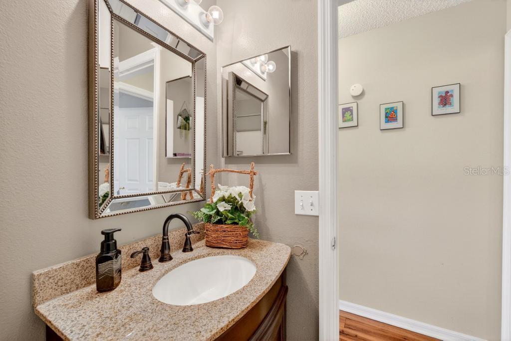 1332 Honey Road Apopka, FL 32712 - Photo 45 of 59 a bathroom with a granite countertop sink and a mirror