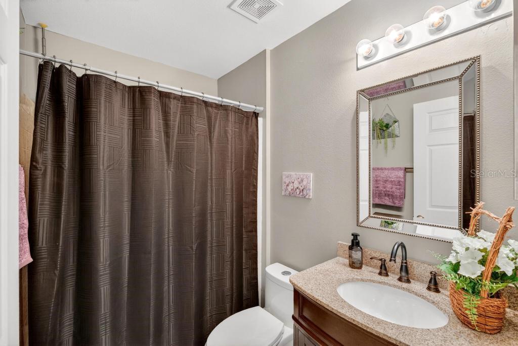 1332 Honey Road Apopka, FL 32712 - Photo 47 of 59 a bathroom with a sink vanity and a mirror