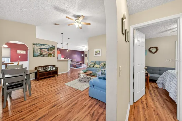 a living room with furniture and wooden floor