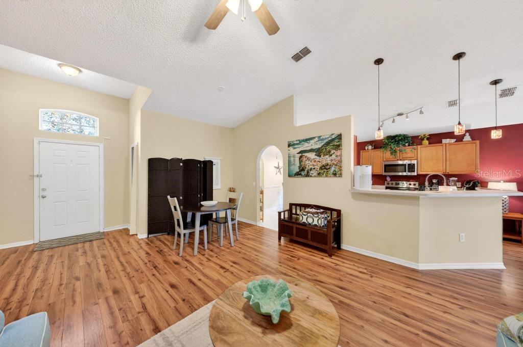 1332 Honey Road Apopka, FL 32712 - Photo 6 of 59 a living room with furniture and a wooden floor