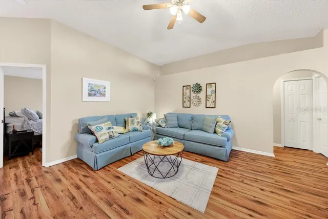 a living room with furniture and wooden floor