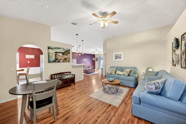 a dining room with furniture and chandelier