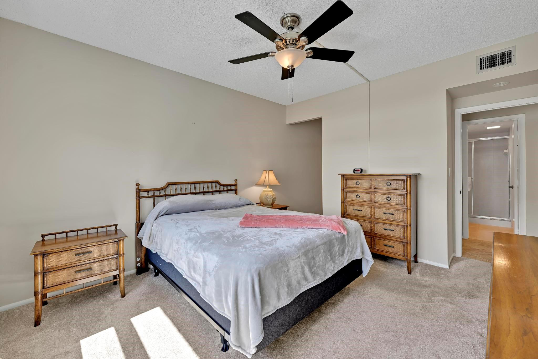 400 North Riverside Drive, Unit 404 Pompano Beach, FL 33062 - Photo 12 of 29 a bedroom with a bed and a chandelier