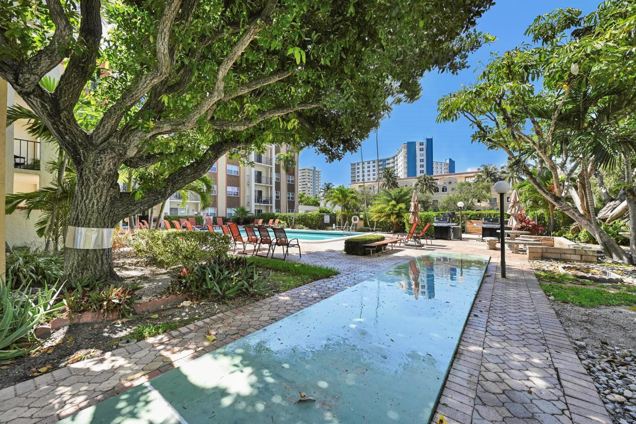 400 North Riverside Drive, Unit 404 Pompano Beach, FL 33062 - Photo 27 of 29 a view of a building with sitting area and garden