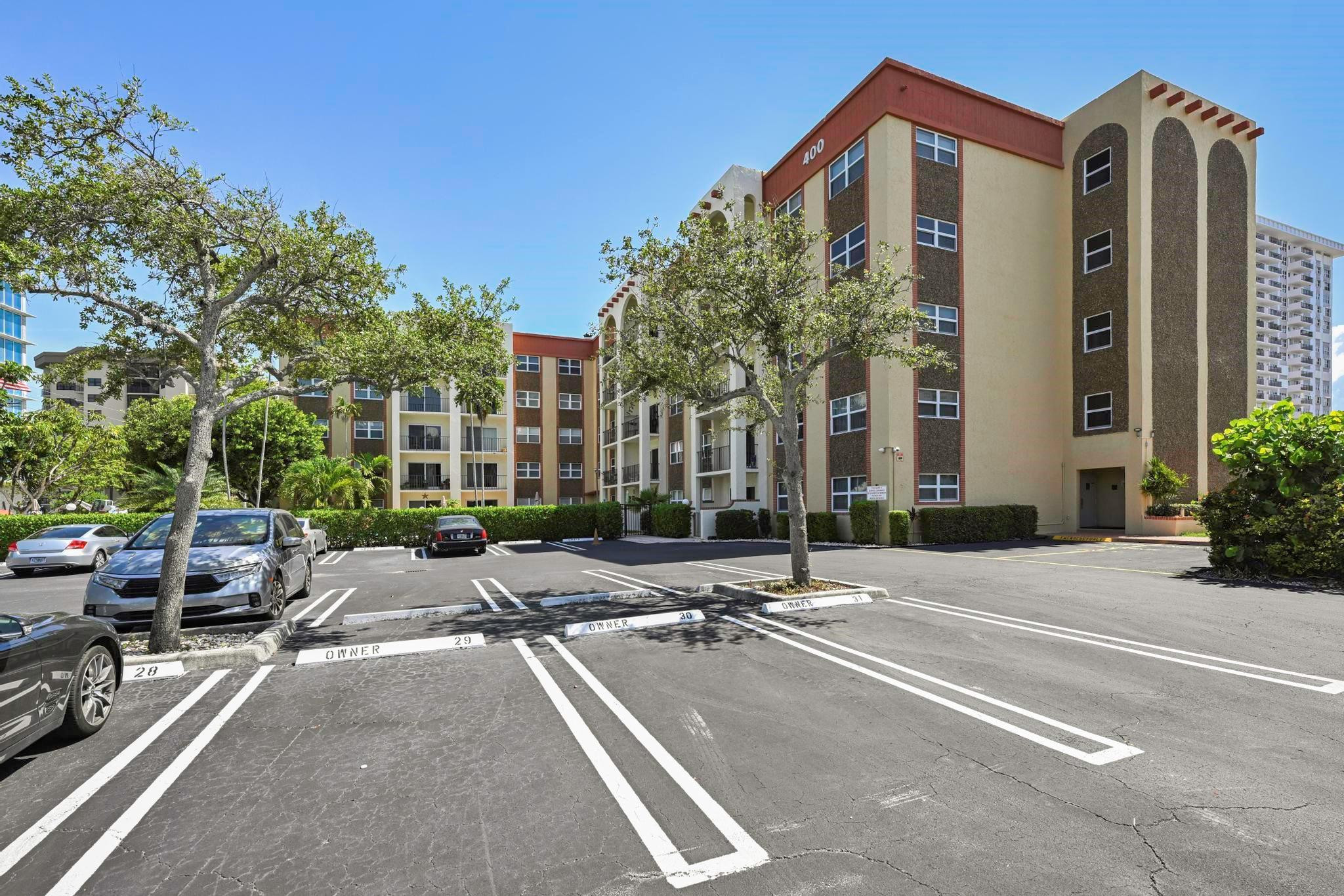 400 North Riverside Drive, Unit 404 Pompano Beach, FL 33062 - Photo 29 of 29 a row of palm trees in front of a building