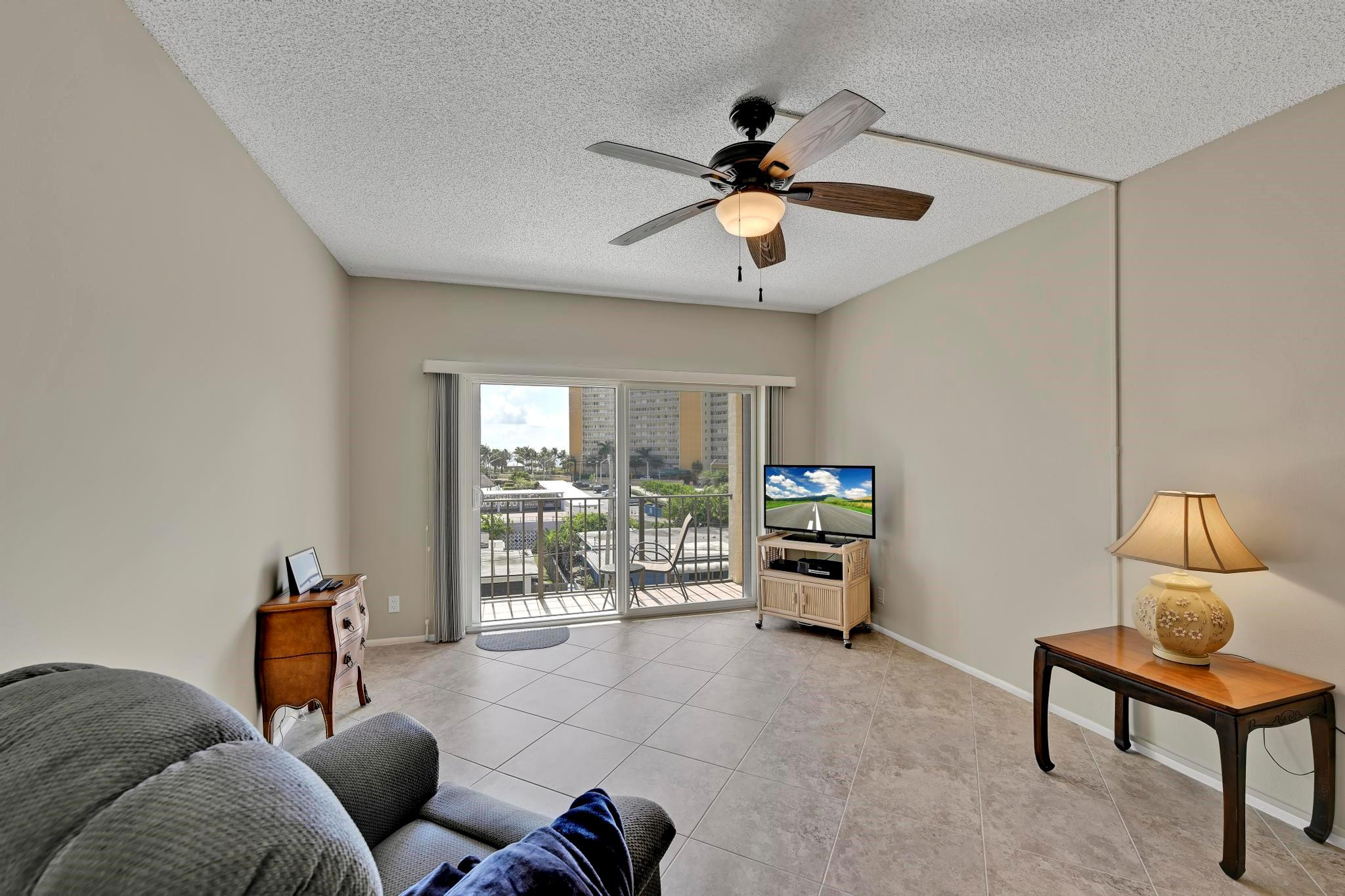 400 North Riverside Drive, Unit 404 Pompano Beach, FL 33062 - Photo 3 of 29 a living room with furniture and a flat screen tv