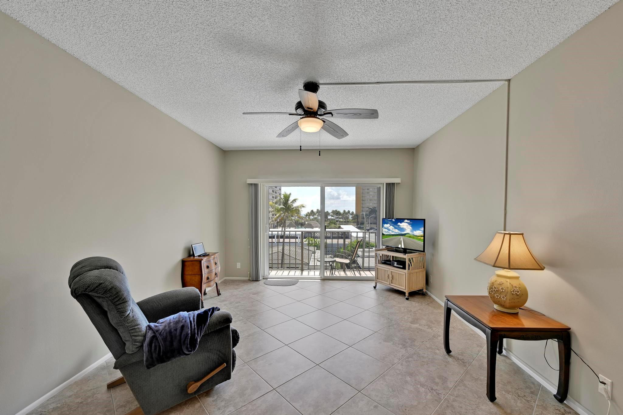 400 North Riverside Drive, Unit 404 Pompano Beach, FL 33062 - Photo 8 of 29 a living room with furniture and a flat screen tv