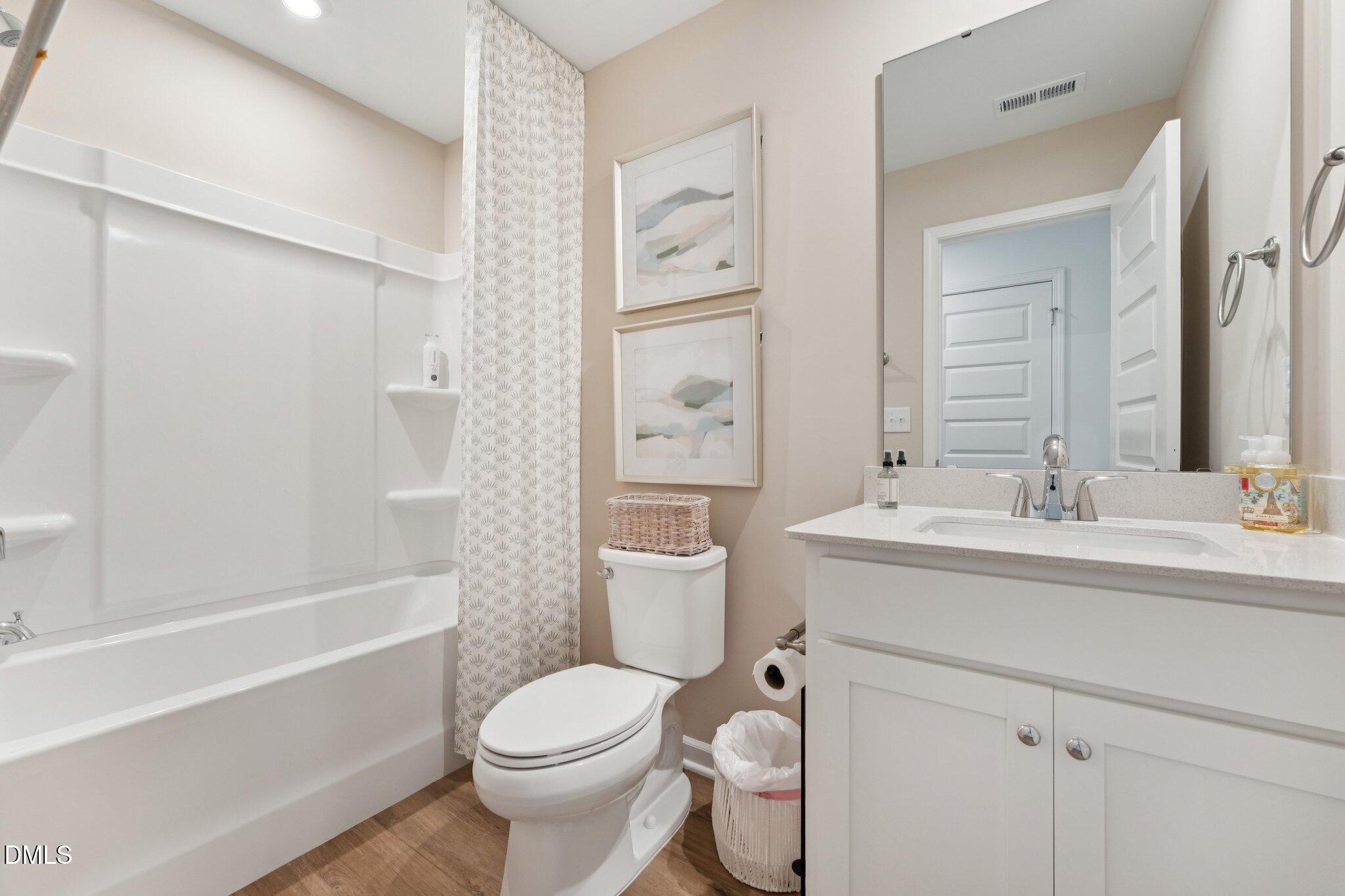 3320 Bomore Road Raleigh, NC 27610 - Photo 6 of 37 a bathroom with a sink toilet vanity and shower