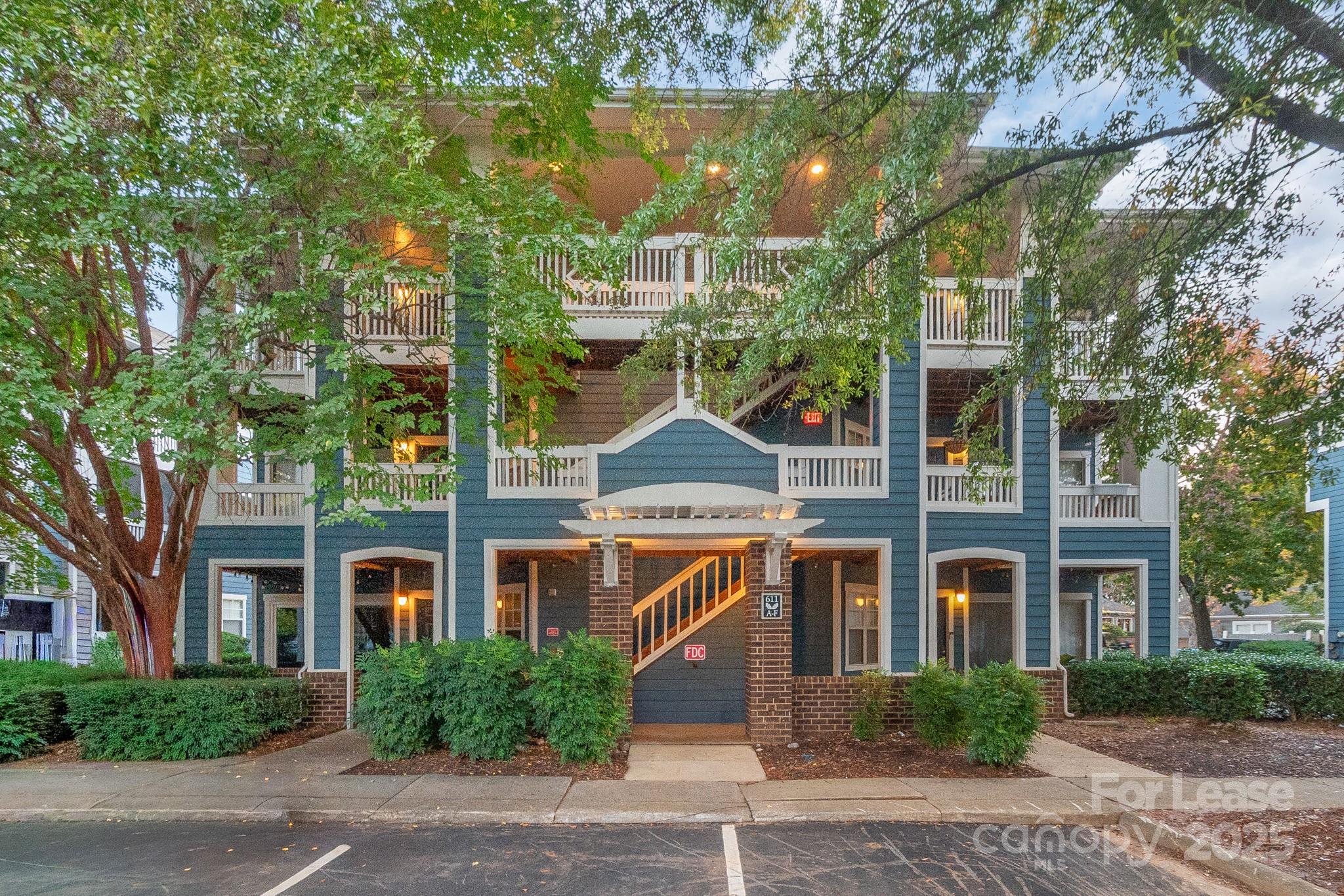 front view of a brick house with a yard