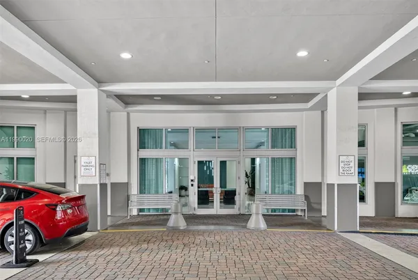 a living room with furniture a rug and a chandelier
