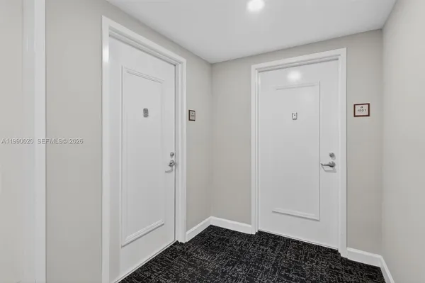 a view of a hallway with wooden floor and closet