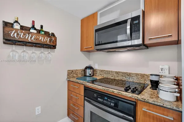 a large kitchen with a table and a clock on the wall