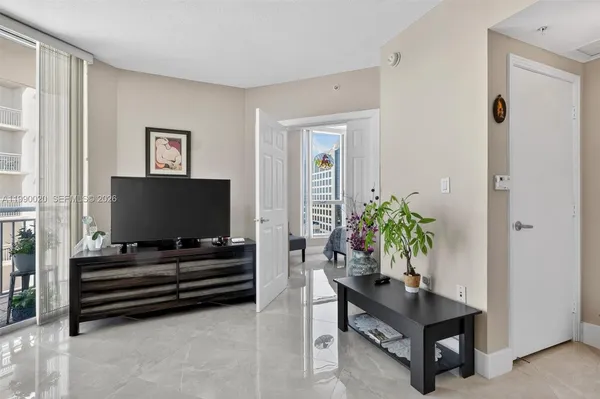 a living room with furniture and a dining table