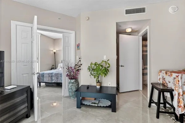 a living room with furniture potted plant and a window
