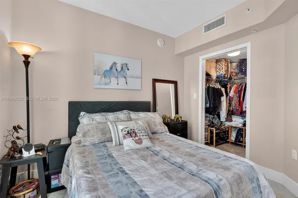 a bedroom with a bed and a couch