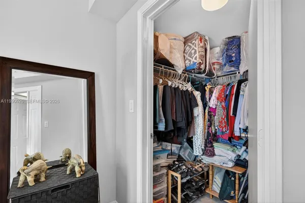a bathroom with a granite countertop sink toilet a mirror a vanity and shower