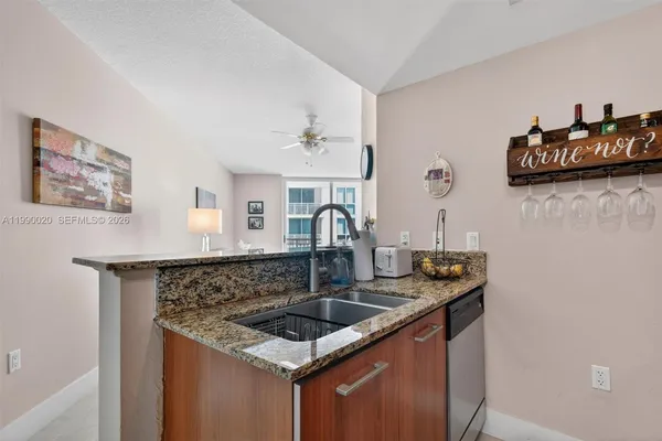 a kitchen with stainless steel appliances granite countertop a stove a microwave and a refrigerator