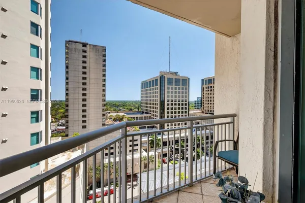 a balcony with furniture and wooden floor