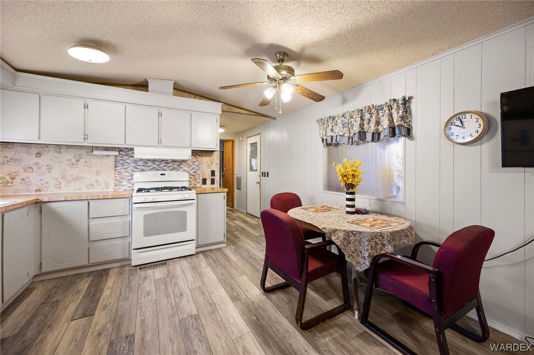 4053 Cowlic Road Golden Valley, AZ 86413 - Photo 15 of 25 a kitchen with stainless steel appliances a dining table chairs and a refrigerator