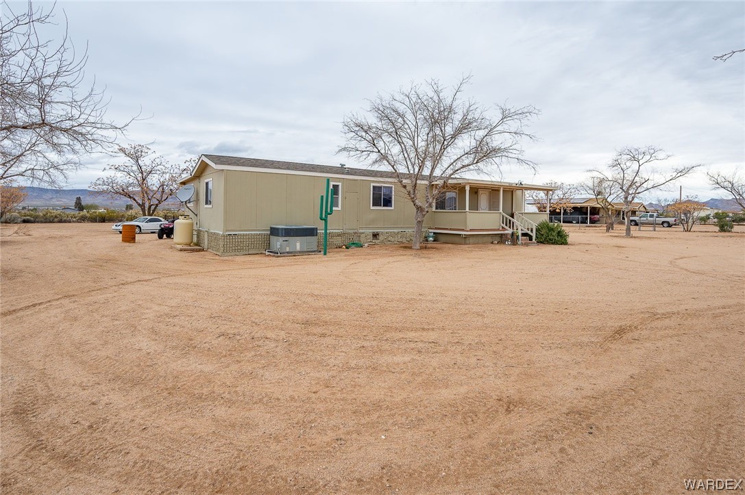 4053 Cowlic Road Golden Valley, AZ 86413 - Photo 3 of 25 a front view of house with yard and trees in the background