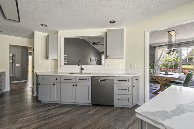 a spacious bathroom with a granite countertop sink mirror and a toilet