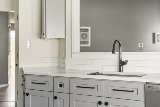 a kitchen with cabinets stainless steel appliances and a sink