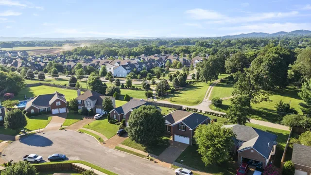an aerial view of residential house with outdoor space and swimming pool
