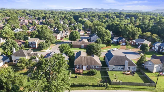 an aerial view of multiple houses with yard