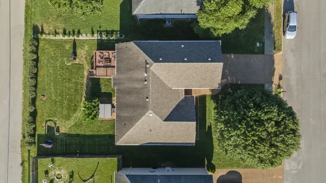 an aerial view of a house with a yard