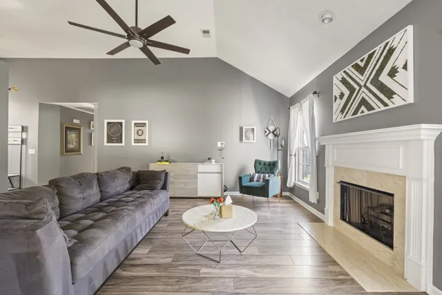 a living room with furniture and a fireplace
