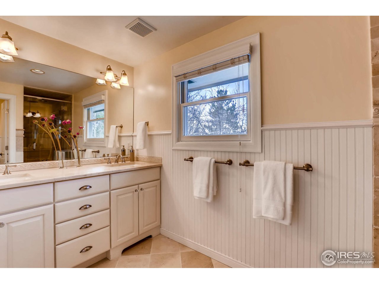 2610 Regis Drive Boulder, CO 80305 - Photo 12 of 29 a bathroom with a granite countertop sink a mirror and shower