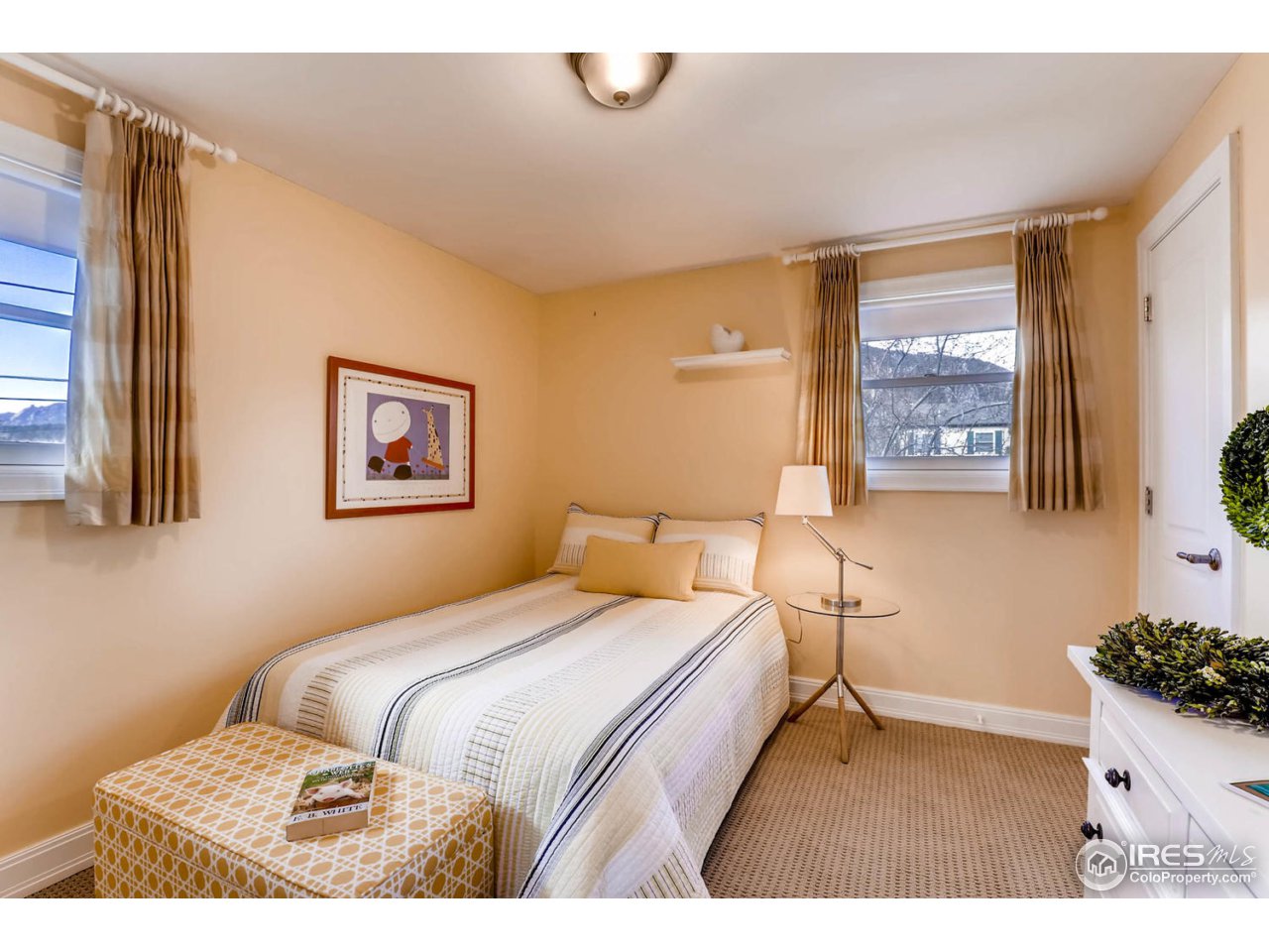 2610 Regis Drive Boulder, CO 80305 - Photo 15 of 29 a bedroom with a bed and a painting on the wall