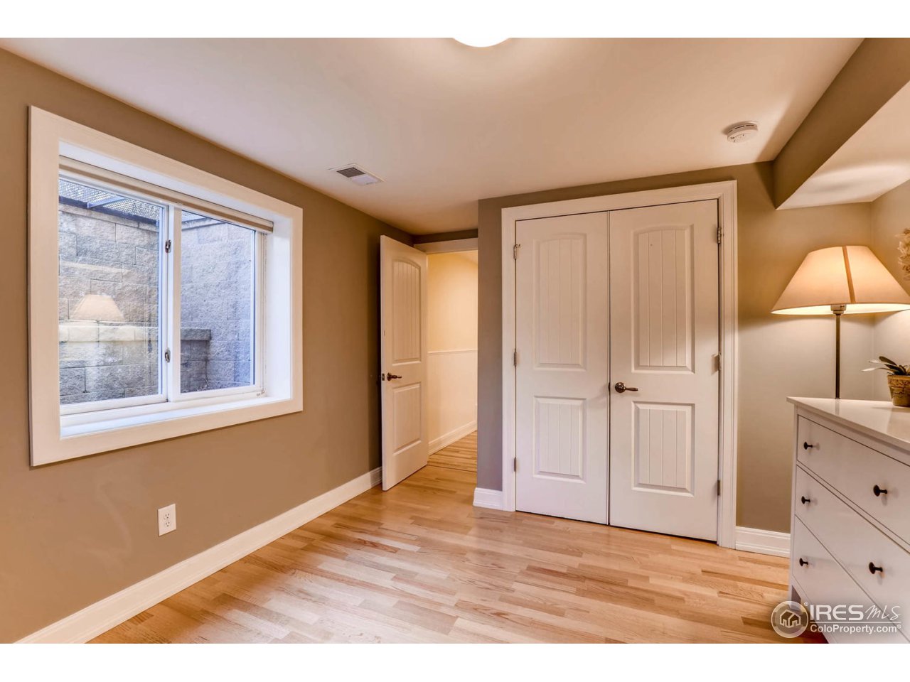 2610 Regis Drive Boulder, CO 80305 - Photo 19 of 29 a view of an empty room with window and wooden floor