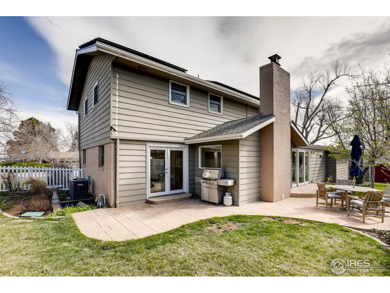 2610 Regis Drive Boulder, CO 80305 - Photo 24 of 29 a front view of a house with a yard and potted plants