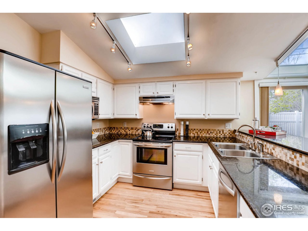 2610 Regis Drive Boulder, CO 80305 - Photo 4 of 29 a kitchen with stainless steel appliances granite countertop a sink a stove and a refrigerator