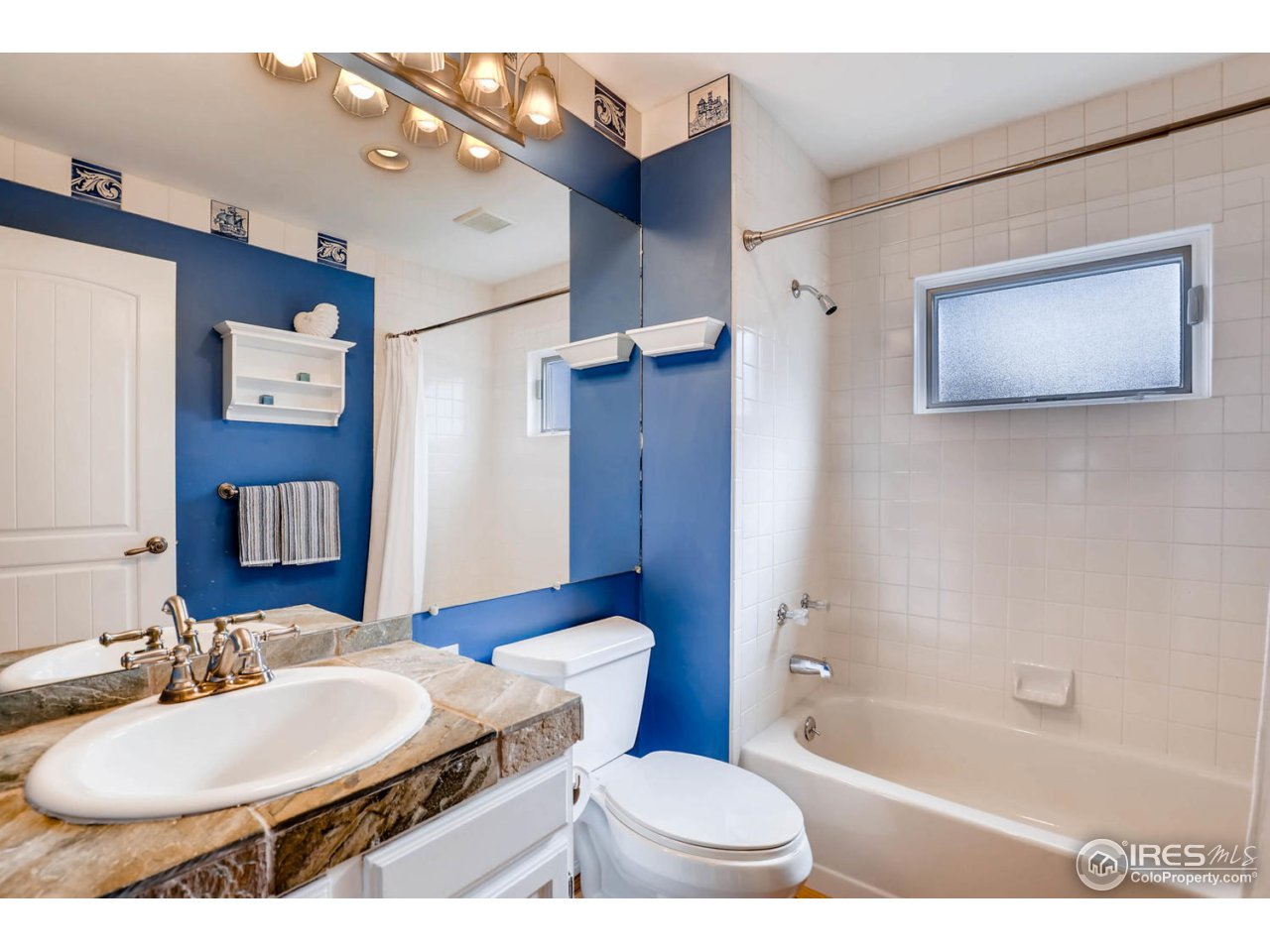 2610 Regis Drive Boulder, CO 80305 - Photo 8 of 29 a bathroom with a sink a toilet a mirror and shower