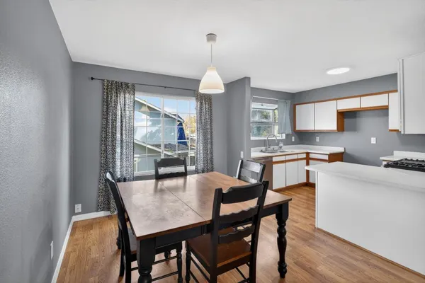 a kitchen with granite countertop a stove and a white cabinets