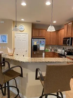 a kitchen with stainless steel appliances granite countertop a sink and a stove