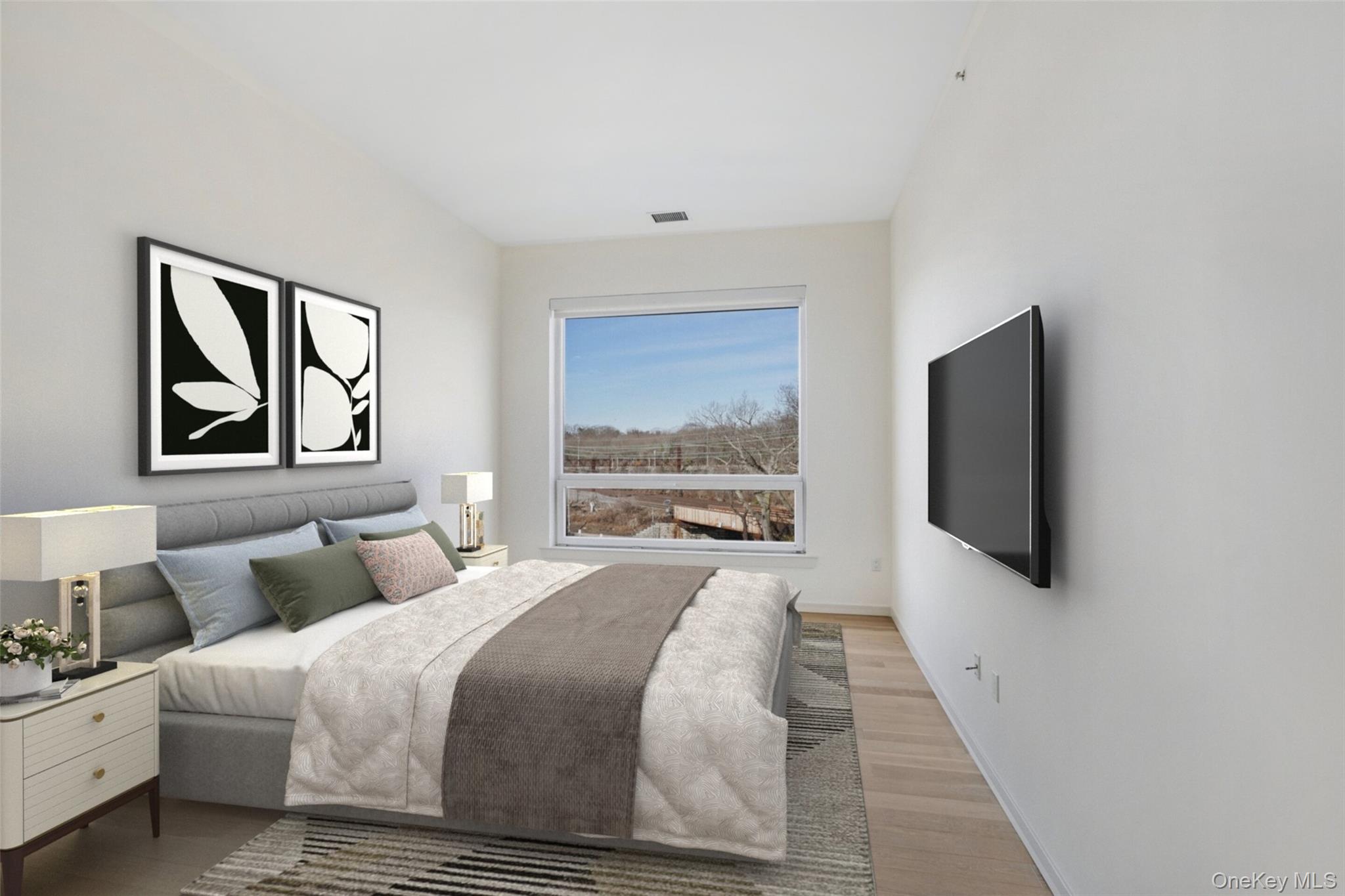 2 2nd Street, Unit 34 Rye, NY 10580 - Photo 4 of 6 Bedroom with visible vents, light wood-style flooring, and baseboards