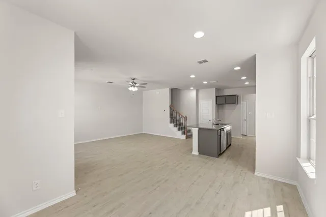 a view of work space with wooden floor and windows