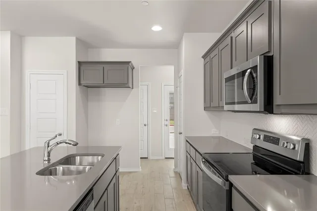a kitchen that has a sink and a stove