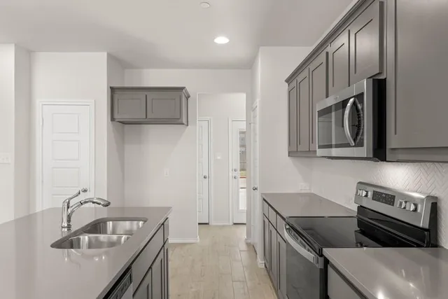 a kitchen that has a sink and a stove