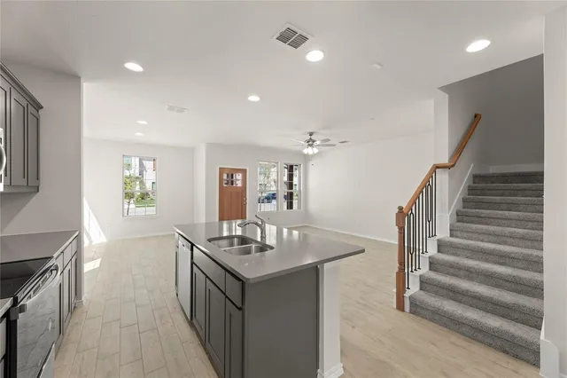 a kitchen with sink and refrigerator
