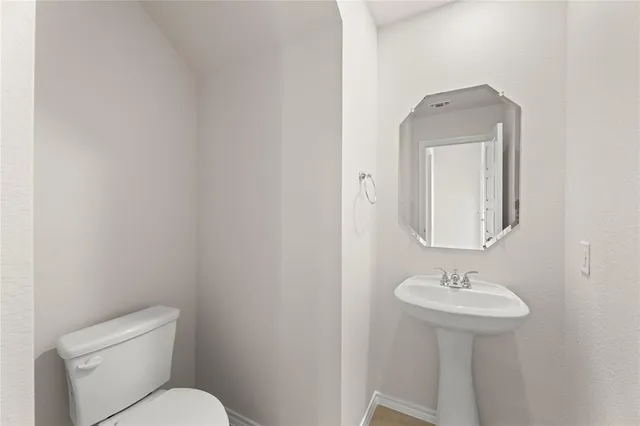 a view of an empty room with a ceiling fan